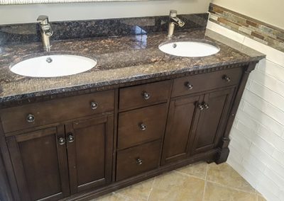 A bathroom with two sinks and a mirror