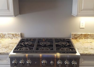 A stove with a hood and a counter top