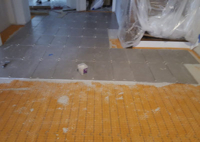 A room with a floor that has been stripped of its tile.
