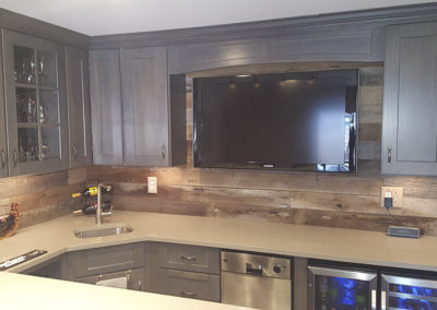 A kitchen with a tv mounted on the wall